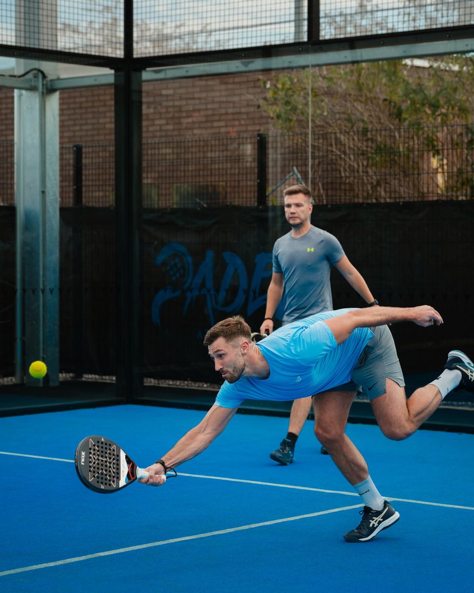 Padel tournament photography: player diving for a low volley