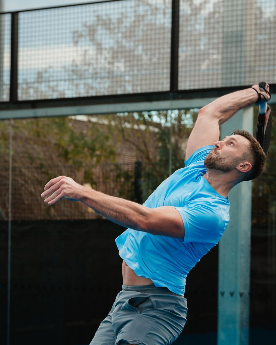 Padel tournament photography: player stretching for an overhead smash